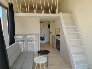 a small apartment with a loft bed and a kitchen at 2 1D2 Mini Condos- Large Studio SW facing in Tivat +2 photos
