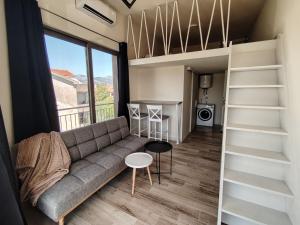 a small living room with a couch and a table at 2 1D2 Mini Condos- Large Studio SW facing in Tivat
