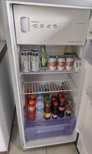 an open refrigerator filled with lots of drinks at Apartamentos El paraiso cerca a Termales - cerca al centro - se aceptan mascotas in Santa Rosa de Cabal +9 photos
