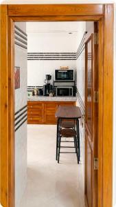 a kitchen with a table and a microwave at appartement in Oujda