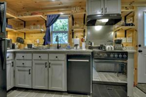 a kitchen with white cabinets and a stove top oven at Ocoee Cottage Water Front in Copperhill +19 photos