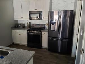 a kitchen with a stainless steel refrigerator and a stove at Family 4BR Home with Spacious Backyard in Coachella +8 photos