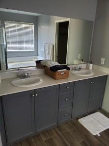a bathroom with two sinks and a mirror at Family 4BR Home with Spacious Backyard in Coachella