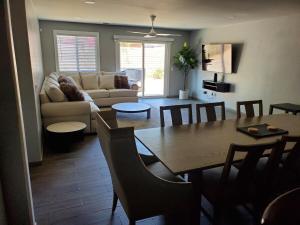 a living room with a table and a couch at Family 4BR Home with Spacious Backyard in Coachella