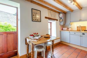 a kitchen with a table and chairs and a window at 1 Bed in Richmond oc-44401 in Reeth +22 photos
