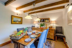 a dining room with a wooden table with a basket of fruit at 1 Bed in Richmond oc-44401 in Reeth
