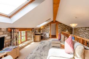 a living room with a stone wall at 1 Bed in Richmond oc-44401 in Reeth