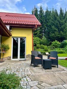 a group of chairs sitting on a patio at Gościniec Saba in Zieleniec