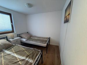 a bedroom with two beds and a window at Landhaus Settin 