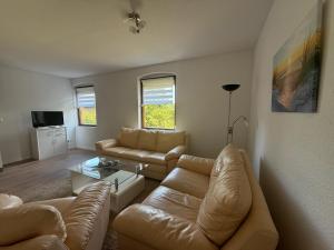 a living room with a couch and a coffee table at Landhaus Settin 