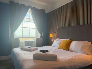 a bedroom with a bed with two towels on it at The Jubilee Hotel West- with NEWLY REFURBISHED SPA FACILITIES - GAMESPIT - AND SMOKEHOUSE in Weymouth +86 photos