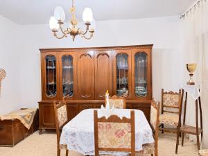 a dining room with a table and a china cabinet at Agriturismo Siviglia in Tocci