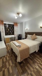 a bedroom with a large bed and a window at Hospedaje Ariana in Supe +13 photos