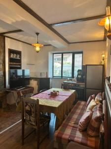 a living room with a table and a couch at Къща за гости "При Примо" in Zlatograd