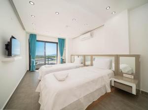 a bedroom with two beds and a flat screen tv at Villa Ocak 1 in Kaş +121 photos