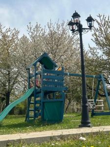 a playground with a slide and a street light at Non stop apartman 2 in Kaposvár