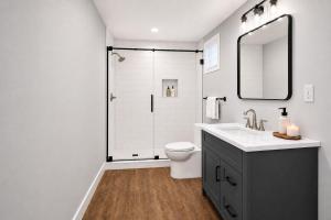 a bathroom with a shower and a toilet and a sink at First Tracks Cabin in Eden
