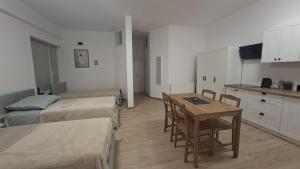 a room with two beds and a table and chairs at Korczakówka in Szczytno