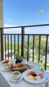 a table with plates of breakfast food on it at Gold ASSN in Cholpon-Ata