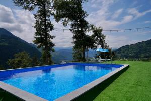 a swimming pool with a view of mountains at Cottage farvana in Khulo