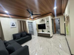 a living room with a couch and a ceiling fan at Brian Castle in Tagum