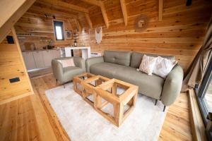 a living room with a couch and a table at Hedwig cottages 1 in Njegovuđa