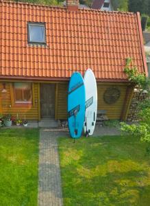 two surfboards standing in the yard of a house at Sauļuki in Ventspils