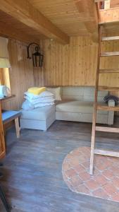 a room with a bunk bed and a ladder at Sauļuki in Ventspils