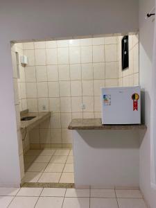 a small white refrigerator sitting on a counter in a bathroom at Pousada Brisa dos Mares Macaé in Macaé +92 photos