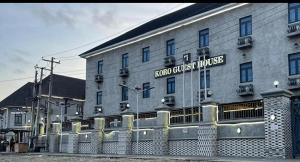 a large building with a fence in front of it at Koro Guess House in Lagos