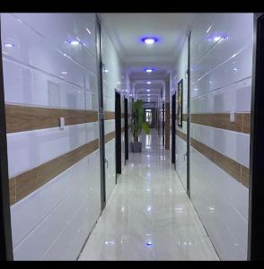 a hallway of a building with a potted plant at Koro Guess House in Lagos