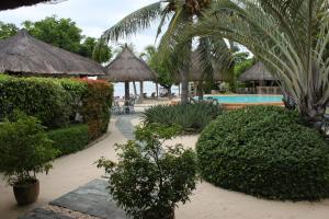 a resort with a swimming pool and trees and bushes at Linaw Beach Resort in Panglao