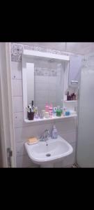 a bathroom with a sink and a mirror at Grand joli F3 Draria 7P in Draria +8 photos