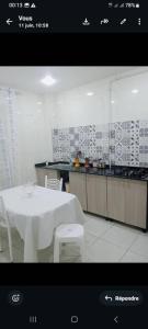 a kitchen with a white table and white chairs at Grand joli F3 Draria 7P in Draria