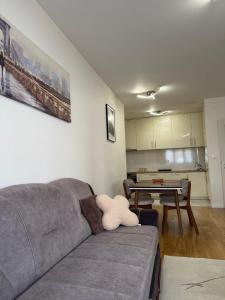 a living room with a couch and a table at Apartment Central Point - Podgorica in Podgorica