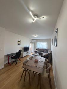 a living room with a couch and a table at Apartment Central Point - Podgorica in Podgorica