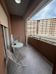a balcony with a table and chairs on a building at Apartment Central Point - Podgorica in Podgorica +49 photos