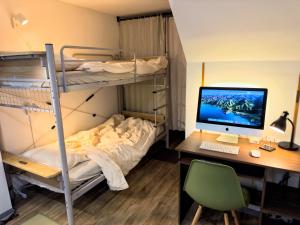 a bedroom with a bunk bed and a desk with a computer at Maison Stay Kobe in Kobe