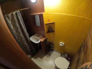 a small bathroom with a sink and a toilet at Kamaq Hostel in Humahuaca +41 photos