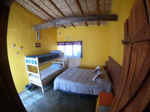 a small room with a bunk bed and a bunk bed at Kamaq Hostel in Humahuaca