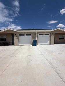 a house with two garage doors in a driveway at Desert Sun Oasis in Page
