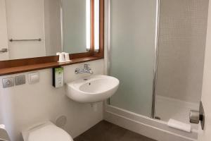 a bathroom with a sink and a toilet and a shower at Hôtel Campanile Orléans Nord - Saran in Saran