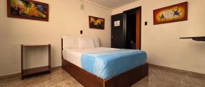 a bedroom with a bed in a room at Hotel el Duque Internacional, Bogotá in Bogotá
