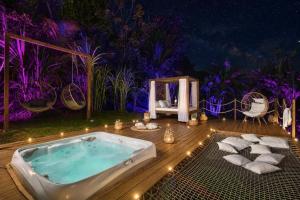 a jacuzzi tub sitting on a deck with lights at Créole Bay - Suites and Spa in Fort-de-France