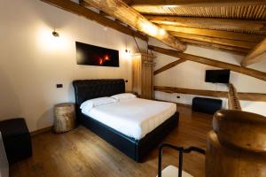 a bedroom with a bed in a room with wooden ceilings at Etna Quota Mille Boutique Hotel, Typical Sicilian Food & Wine in Randazzo
