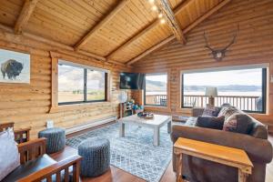 a living room with a couch and a table at Henry's Lake View Cabin + BBQ + Fire Pit + Decks! in Island Park
