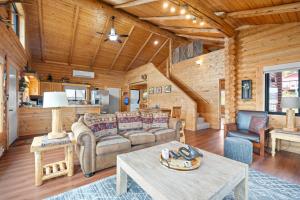 a living room with a couch and a table at Henry's Lake View Cabin + BBQ + Fire Pit + Decks! in Island Park