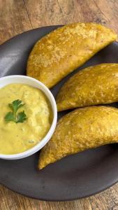 a plate of food with a bowl of dipping sauce at Hostal Jireh in Manta