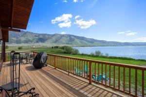 a deck with a view of a lake and mountains at Henry's Lake View Cabin + BBQ + Fire Pit + Decks! in Island Park