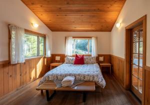 a bedroom with a bed and two windows at Green Springs Inn in Ashland